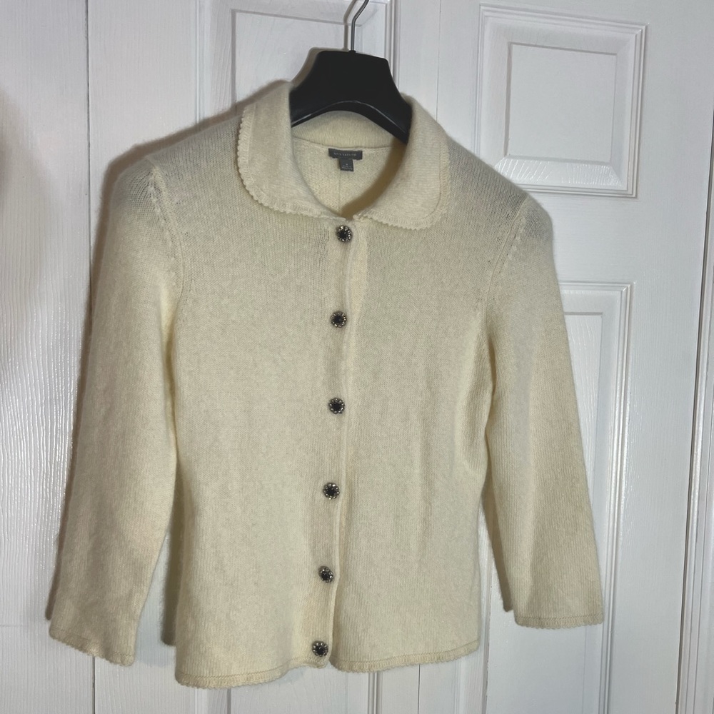 Cream angora sweater with black rhinestone buttons. Size medium.